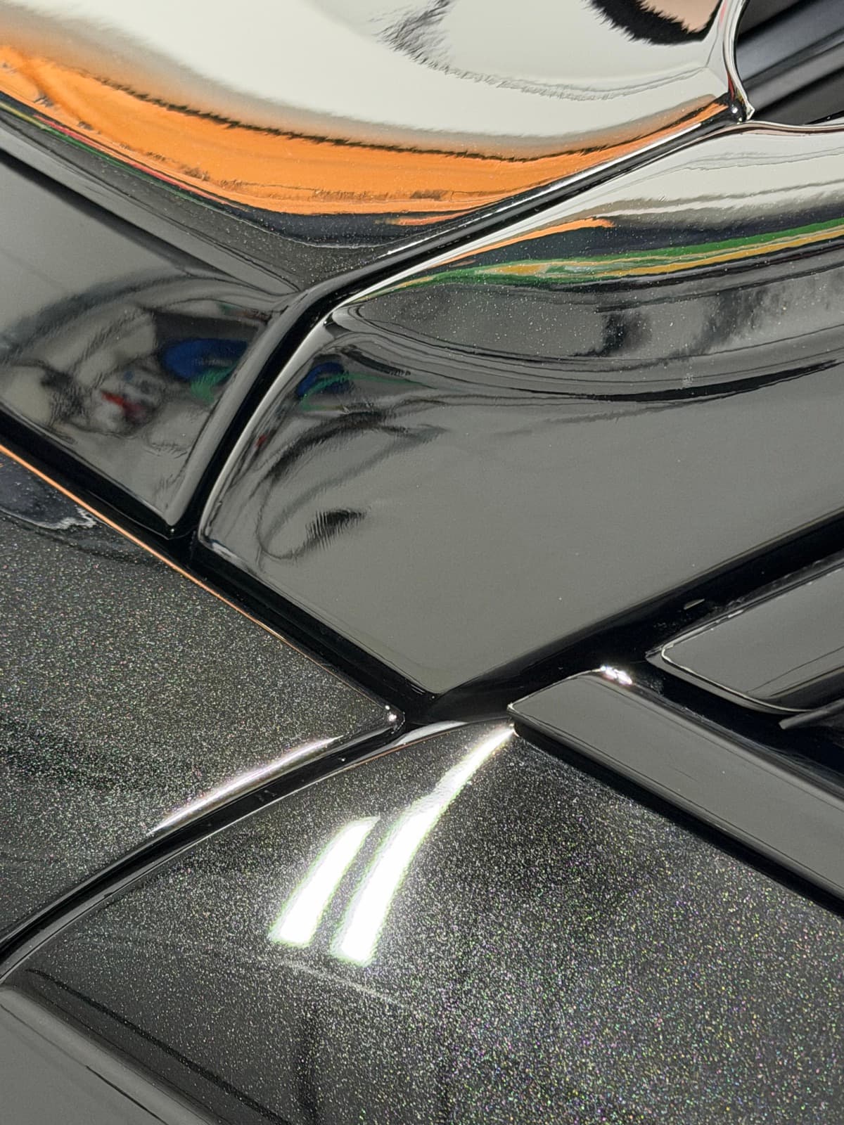 STEK PPF edge wrapped into the panel gap on black gloss paint — no visible seam